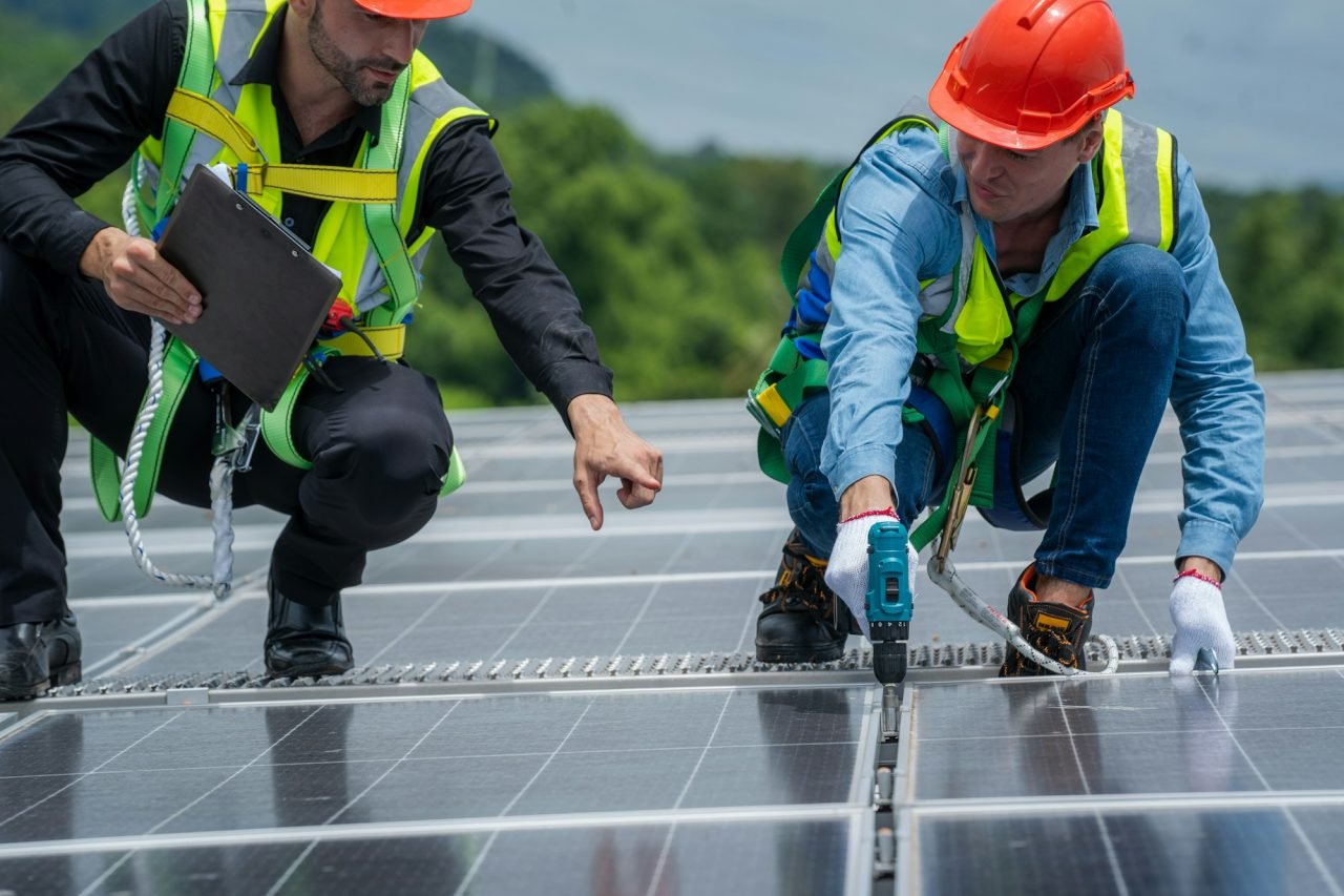 solar power engineer inspect solar panels on the roof of a factory where solar panels .jpg